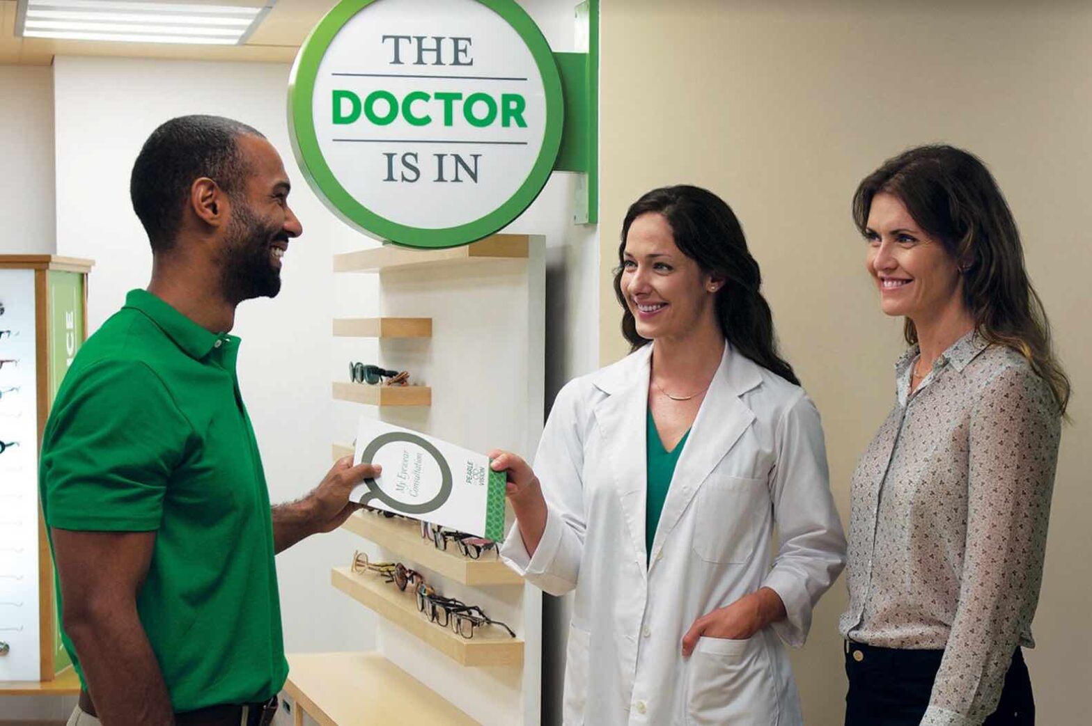 three people standing inside a Pearle Vision