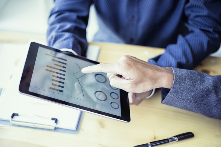 Business people analyzing investment charts on teblet in meeting room, Accounting concept, soft focus, vintage tone