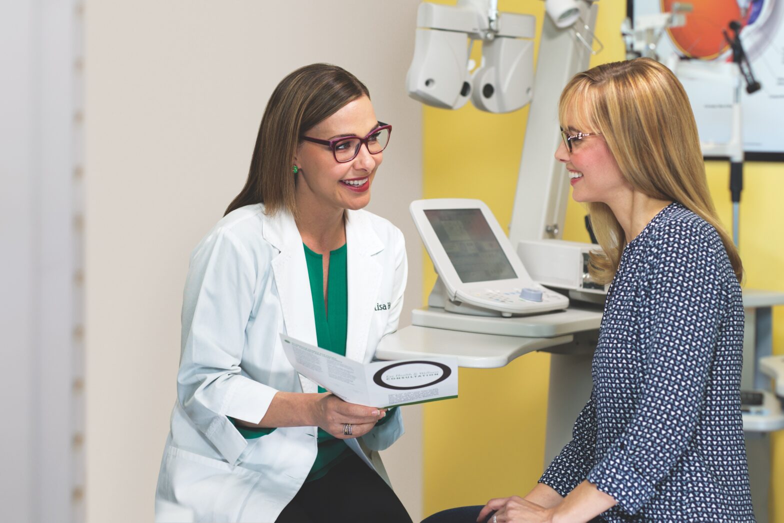 female eye doctor showing a female patient documentation