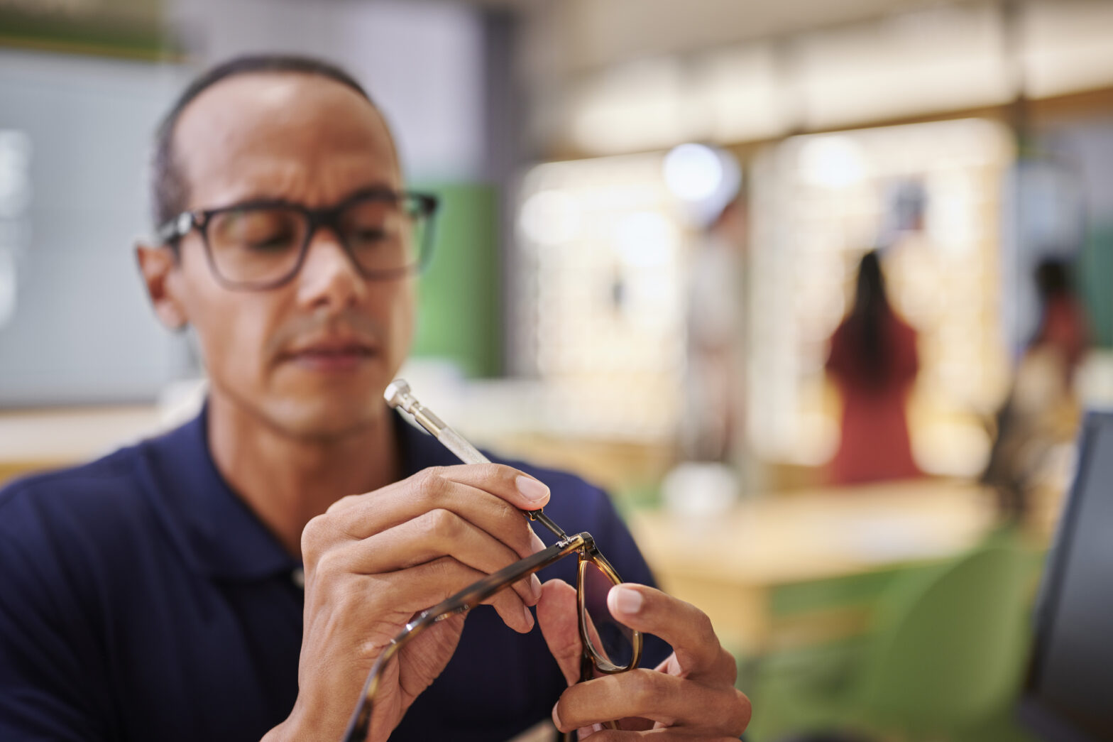 Man repairing a pair of glasses